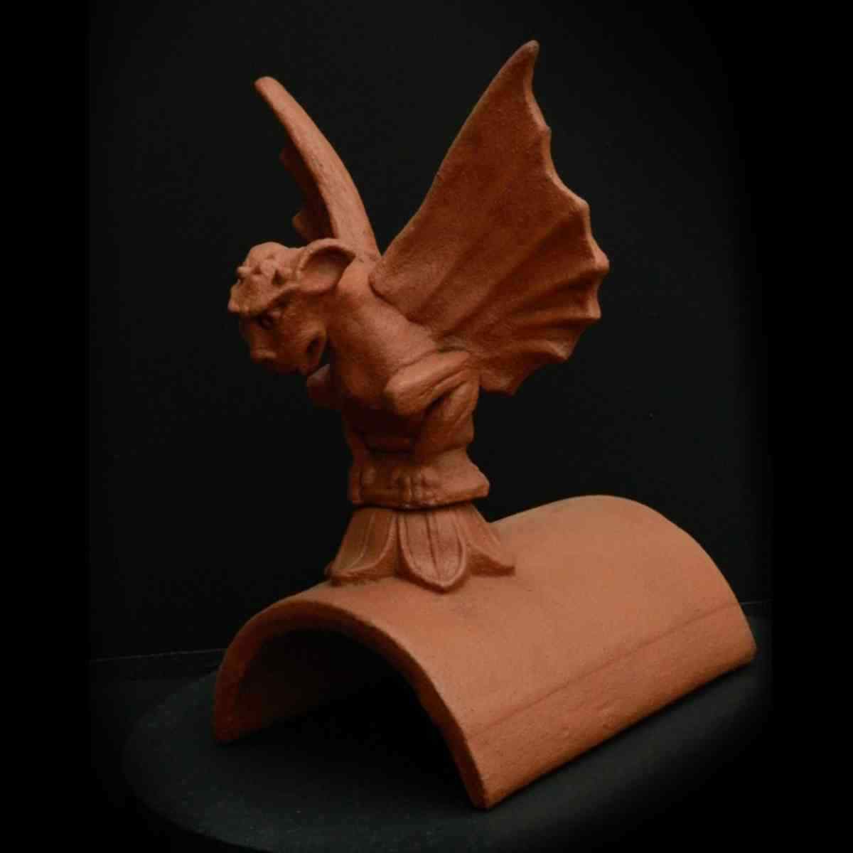 terracotta garoglye with wings on roof tile